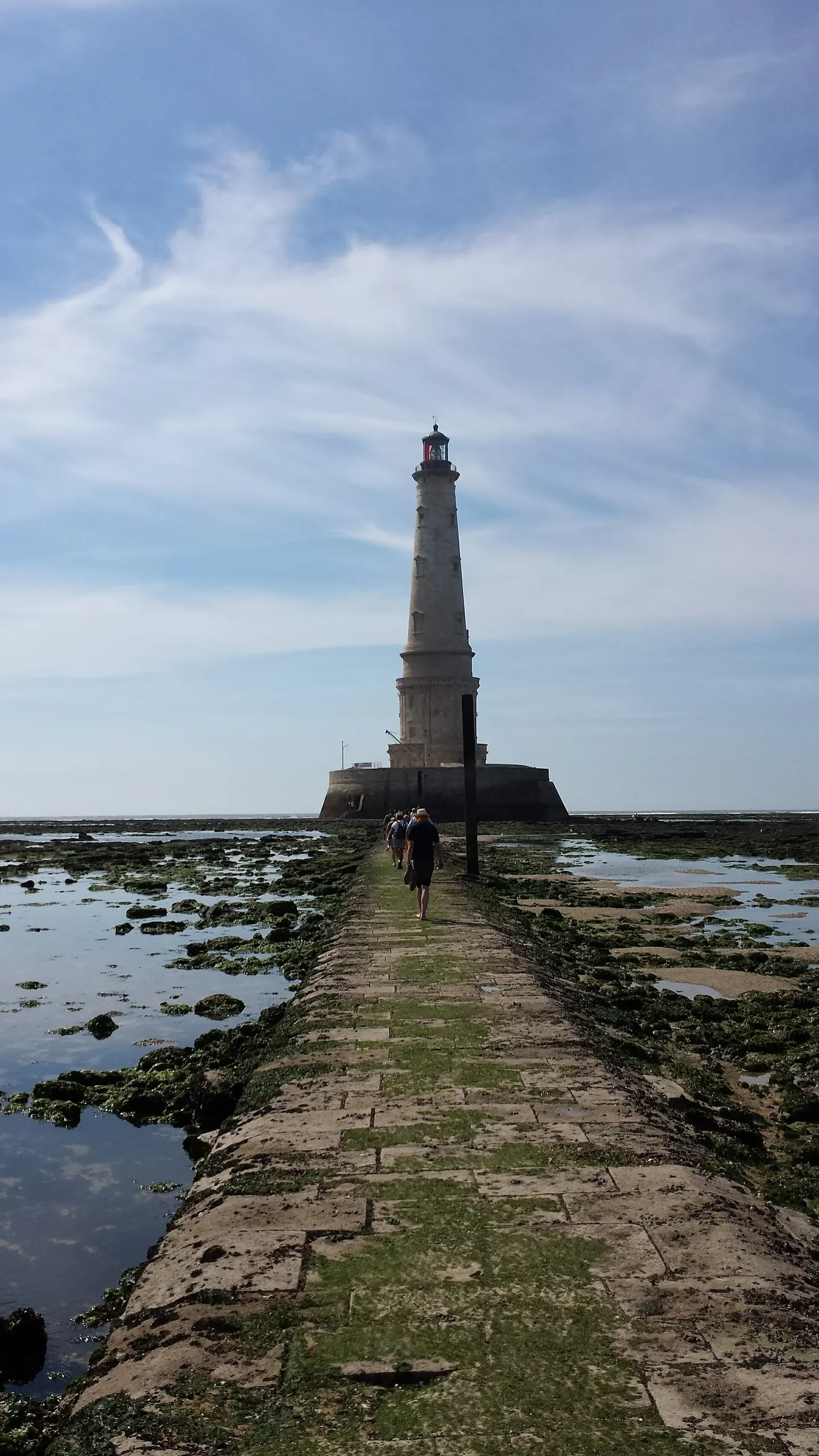 The white stone tower of Cordouan Lighthouse rising from the sea at the mouth of the Gironde estuary
