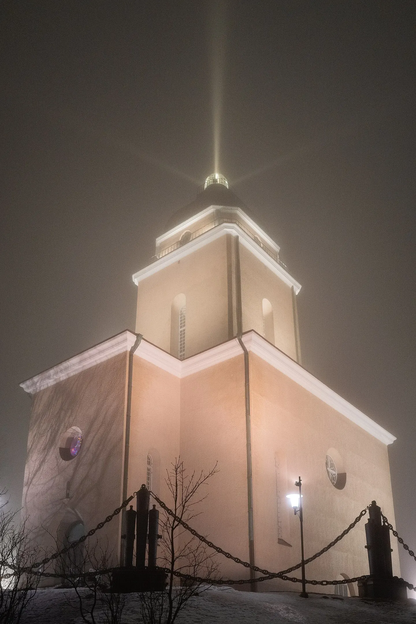A church lantern tower against a winter sky, showing a single unmistakable light rhythm